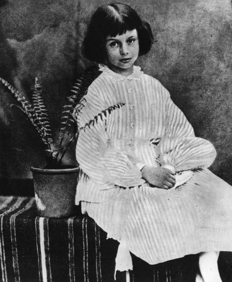 July 1860:  Alice Liddell (1852 - 1934) on whom the heroine of 'Alice's Adventures in Wonderland' (1865) by Lewis Carroll is based, sitting by a potted fern.  (Photo by Lewis Carroll/Getty Images)