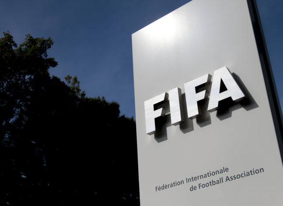 The logo of the global football's governing body FIFA is seen on October 3, 2013 at its headquarters in Zurich. FIFA kicked off a crunch meeting behind closed doors, amid claims of rights abuses by 2022 World Cup Qatar and wrangling over plans to hold the tournament in the winter.  AFP PHOTO / FABRICE COFFRINI        (Photo credit should read FABRICE COFFRINI/AFP/Getty Images)