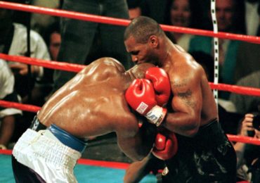 Mike Tyson bites the ear of Evander Holyfield during the third round of the WBA Heavyweight Champion..